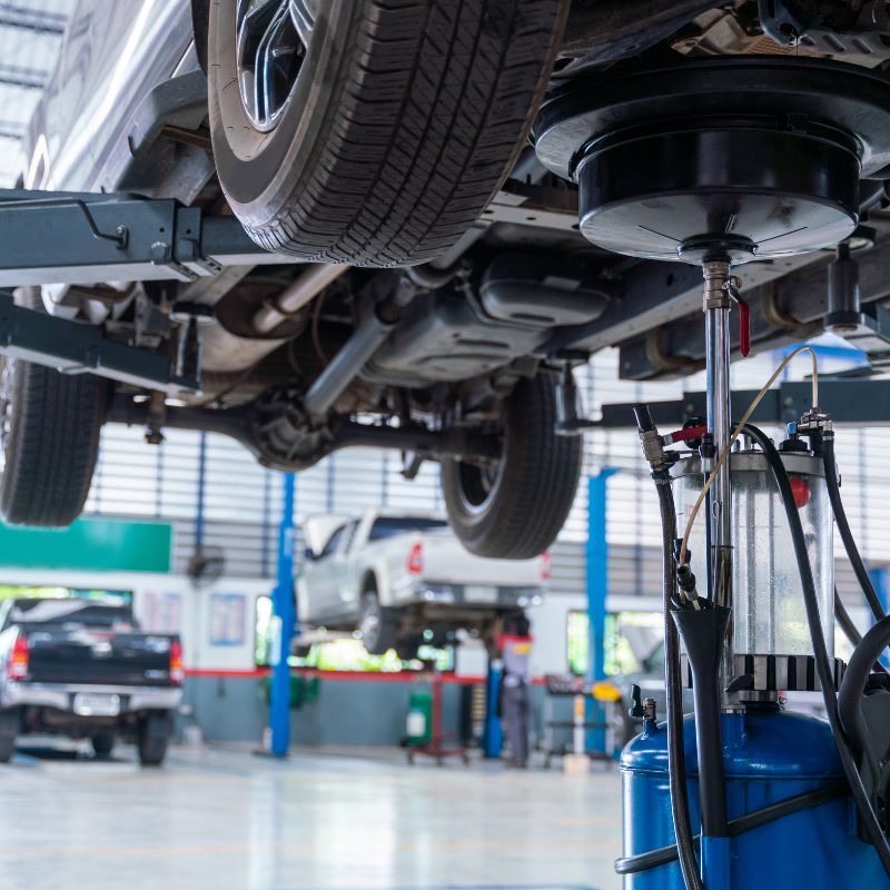 Car raised on a lift in an auto repair shop