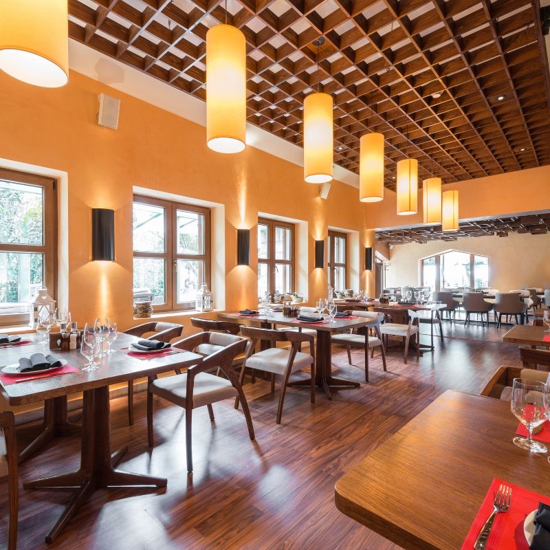 Warm restaurant dining room with set tables