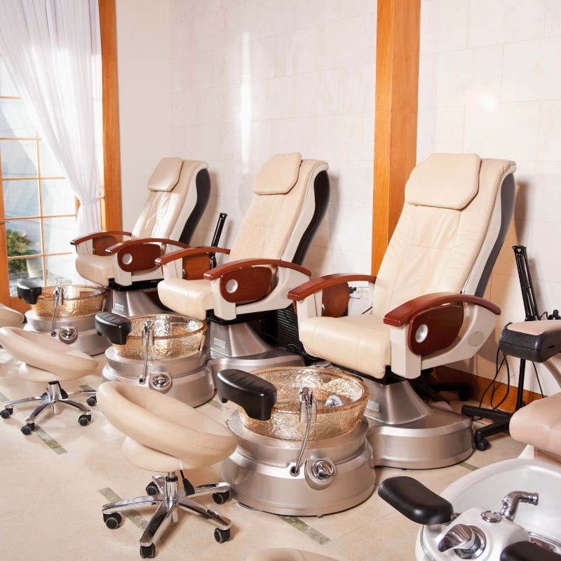 Row of pedicure chairs in a nail salon