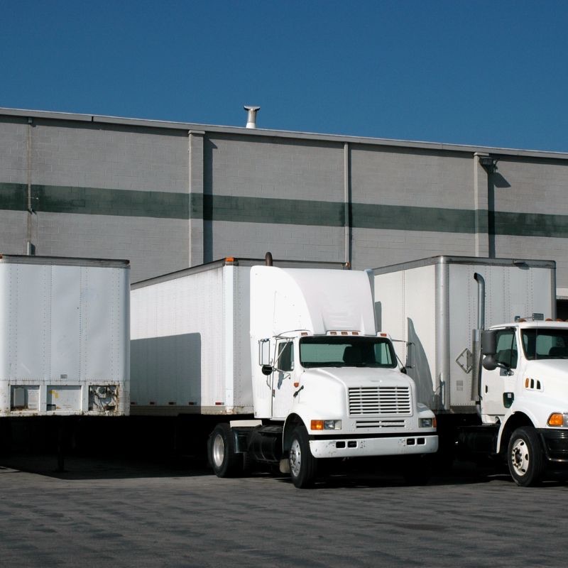 Box trucks backed up to a warehouse loading dock