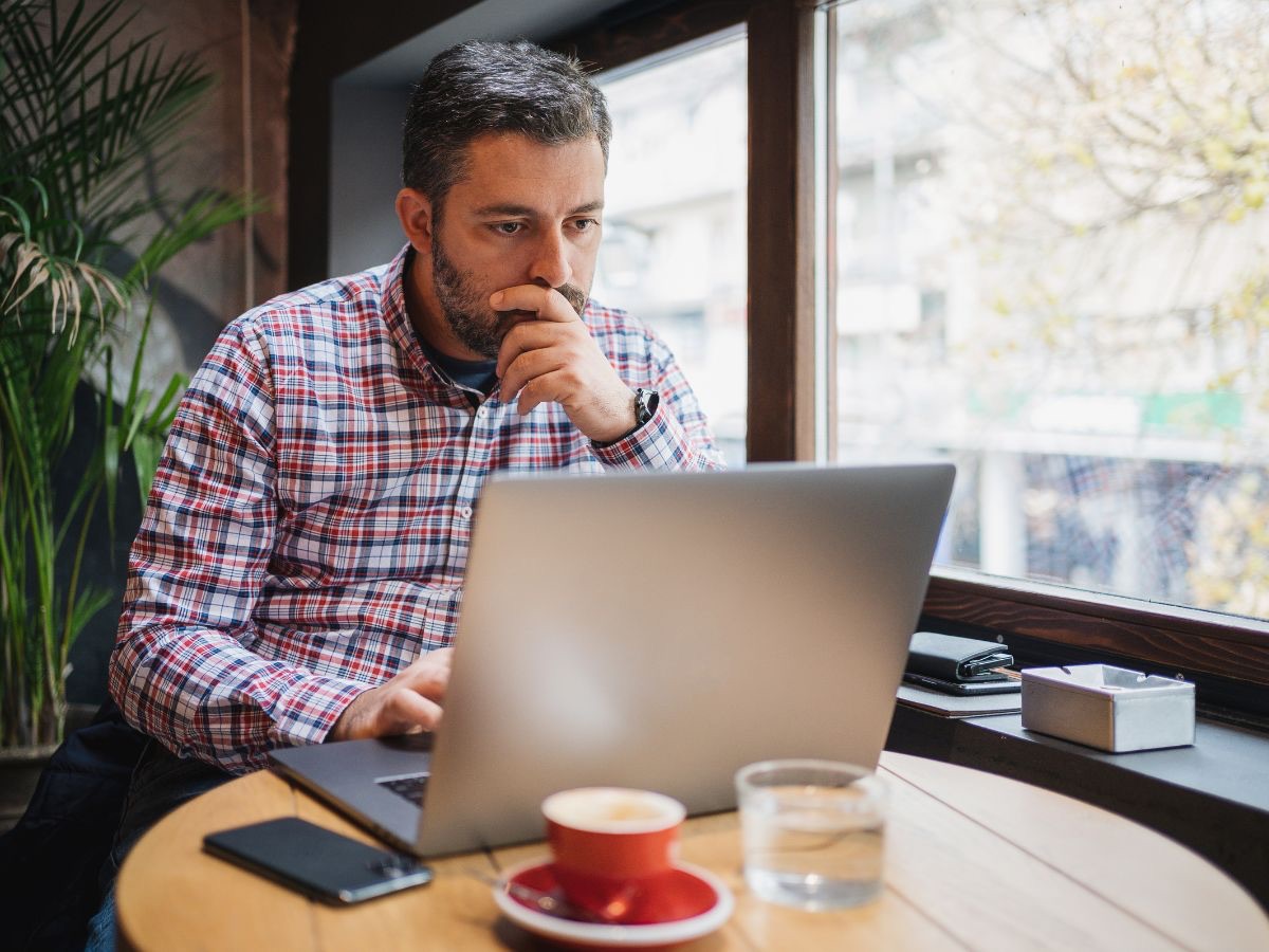 Business owner reviewing sales on a laptop